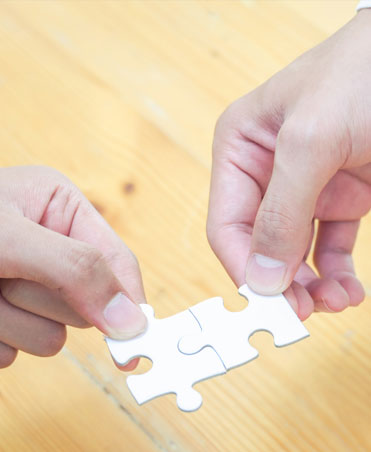 Person Holding White Jigsaw Puzzle Piece